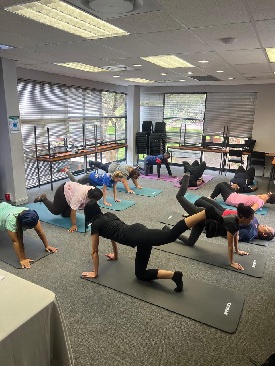 A workplace room set up for a group fitness class