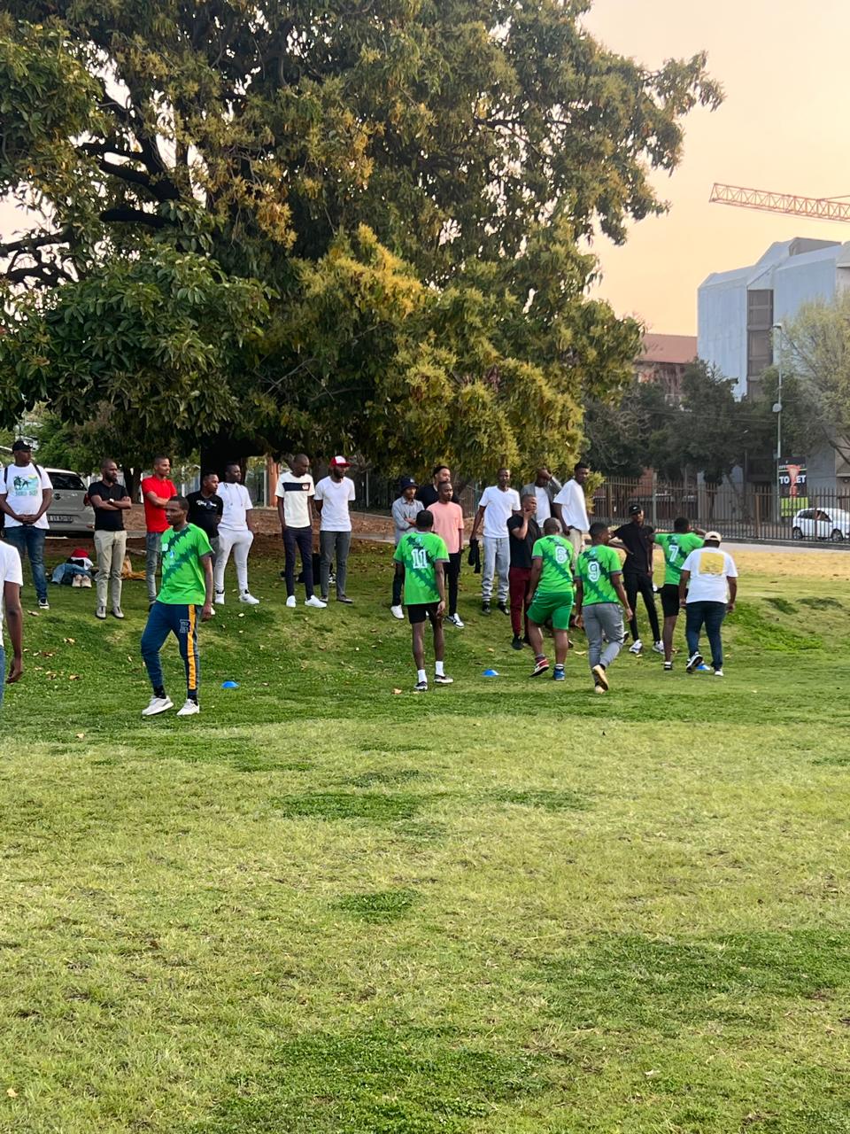 Teams and spectators gathered at an outdoor corporate sports day