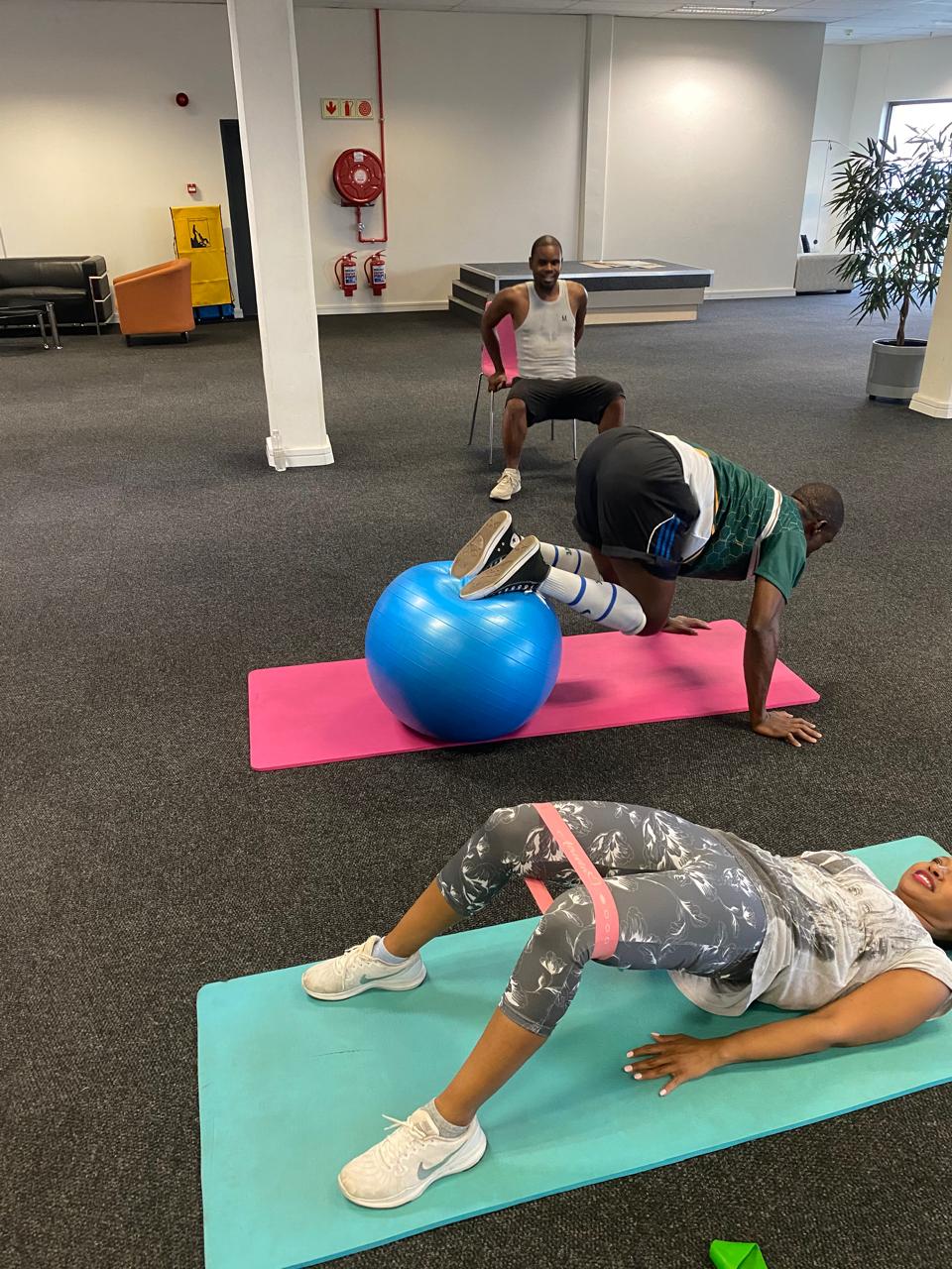 Employees in a mat-based wellness session